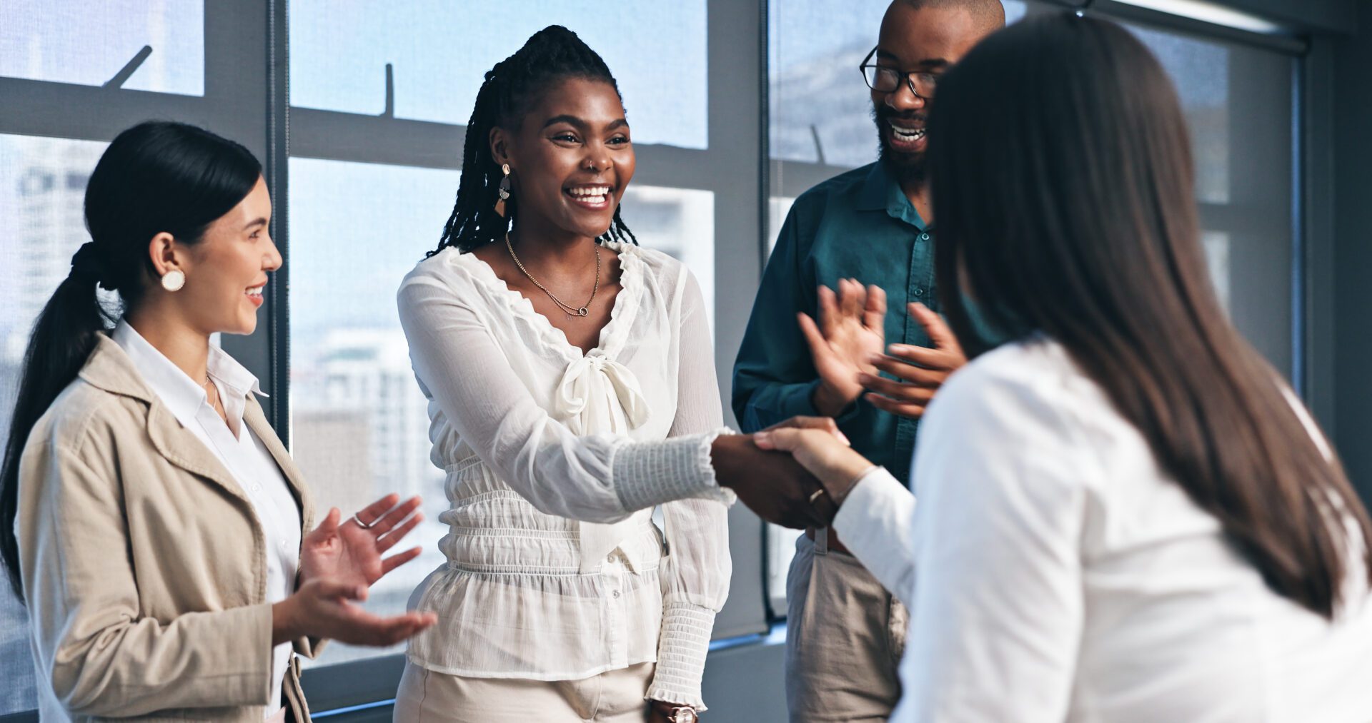 People shaking hands in a business meeting.