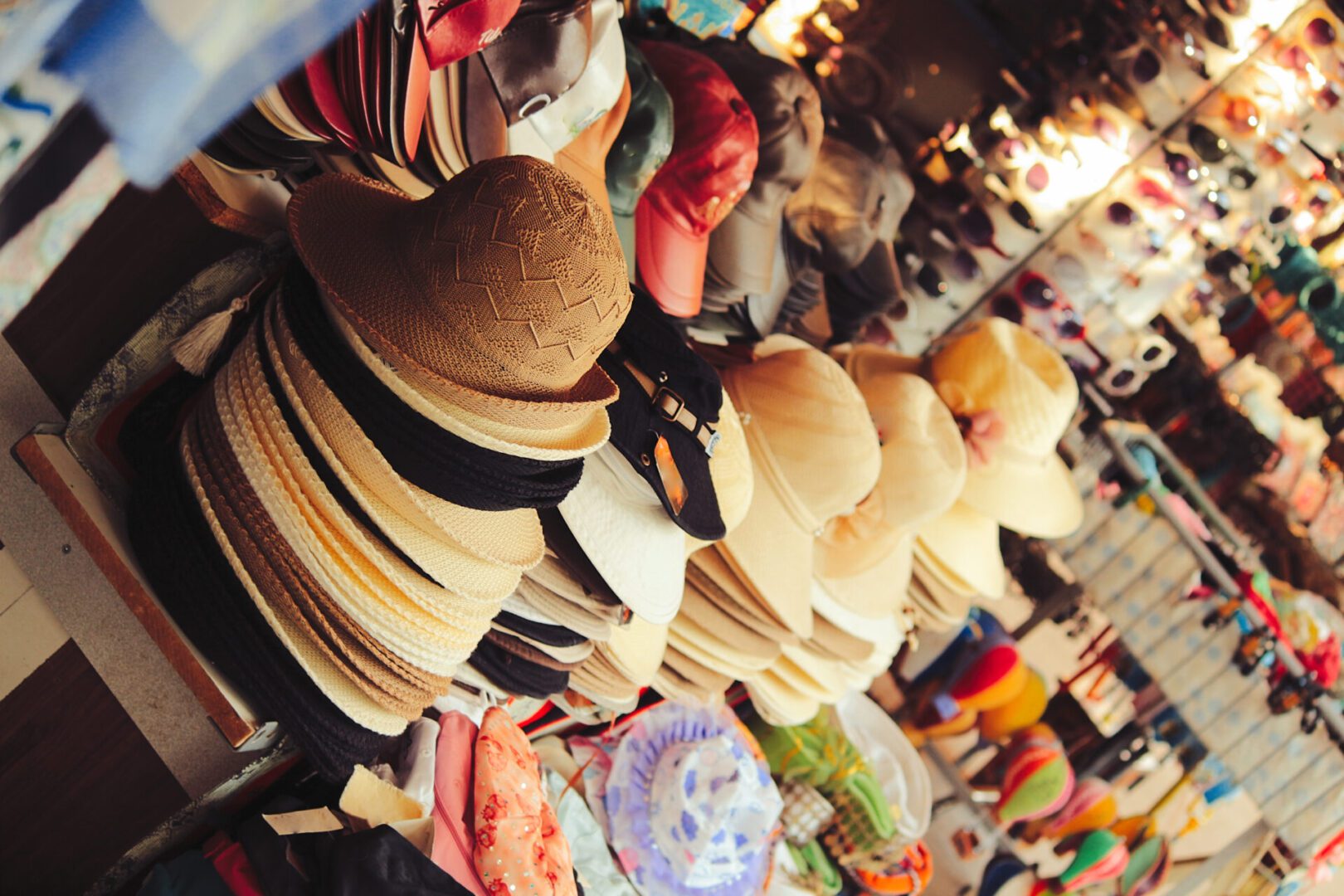 Hats and caps displayed at a market.